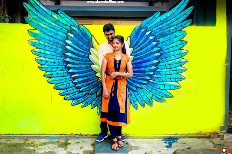 couple standing with the wings on the background as a wall painting