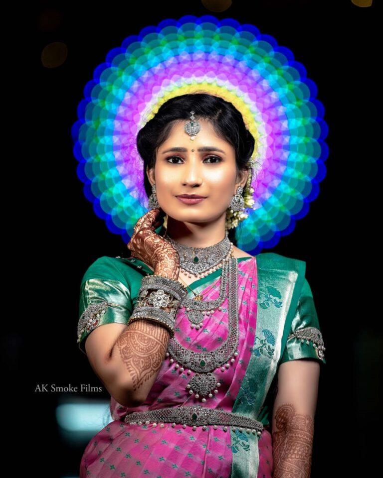 Bride on Indian wedding attire with a blurred image of colored lights in circle behind the head